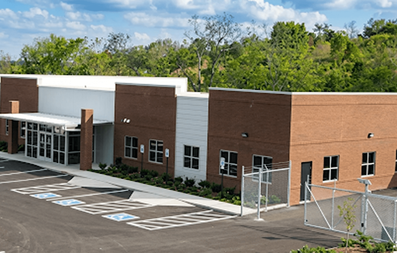 Single-story building surrounded by trees